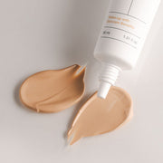 ProtoClinical k-beauty BIODANCE: Skin All-day Cover Balm (30ml) with warm taupe packaging, a centered vertical panel, and a pale aqua right band