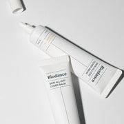 ProtoClinical k-beauty BIODANCE: Skin All-day Cover Balm (30ml) with pale cream packaging, a soft gray vertical center, and a light background