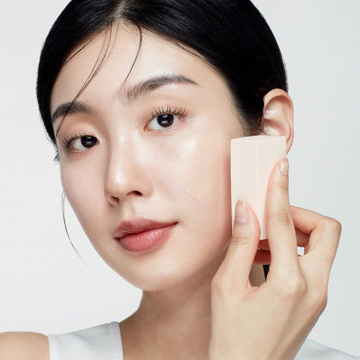 ProtoClinical k-beauty BIODANCE: Skin All-day Cover Balm (30ml) with warm beige packaging, charcoal upper accents, and pale blue side bands