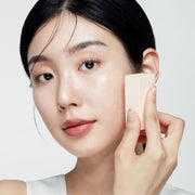 ProtoClinical k-beauty BIODANCE: Skin All-day Cover Balm (30ml) with warm beige packaging, charcoal upper accents, and pale blue side bands