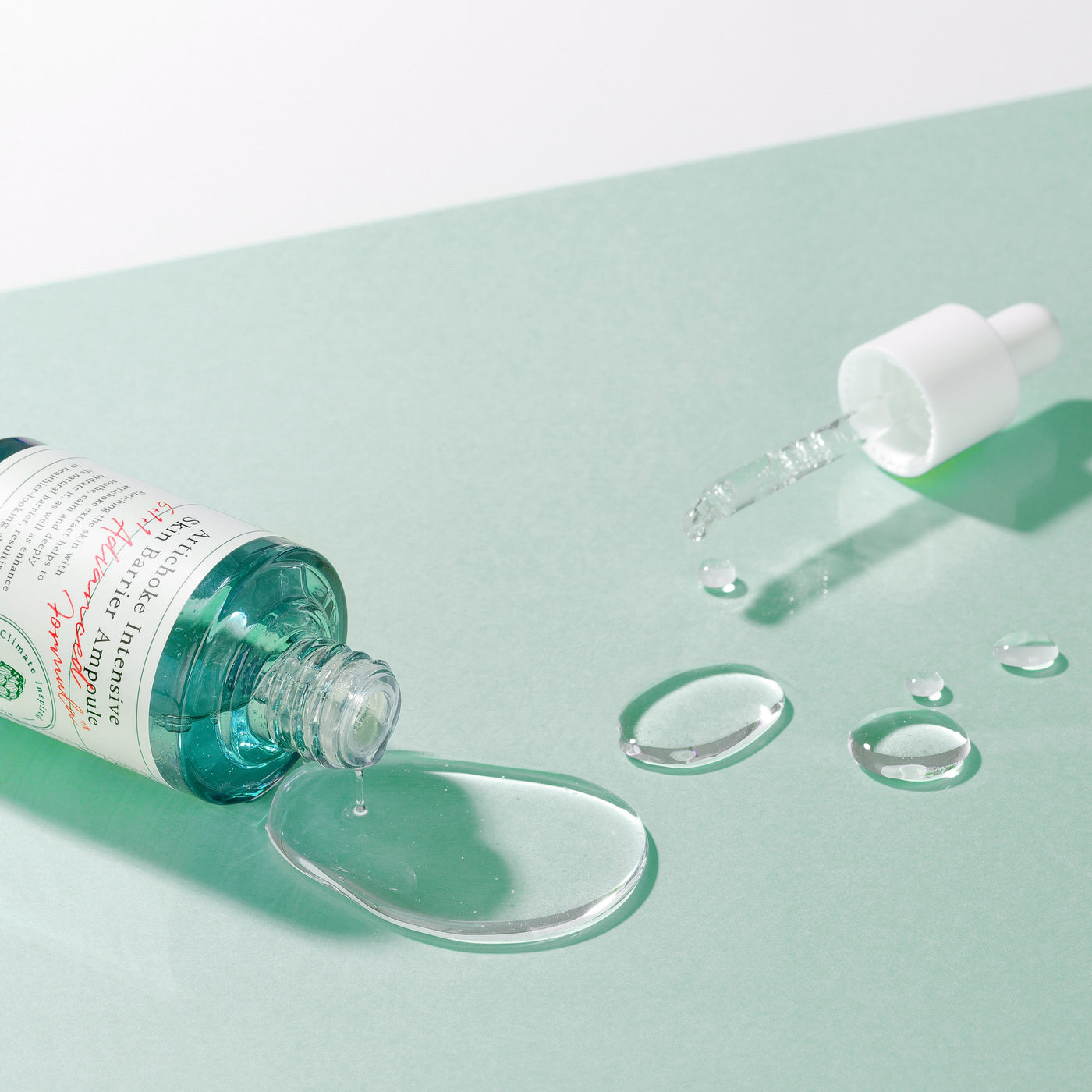ProtoClinical k-beauty AXIS-Y Artichoke Intensive Skin Barrier Ampoule 30ml single brown ampoule bottle centered on a pale aqua and mint background