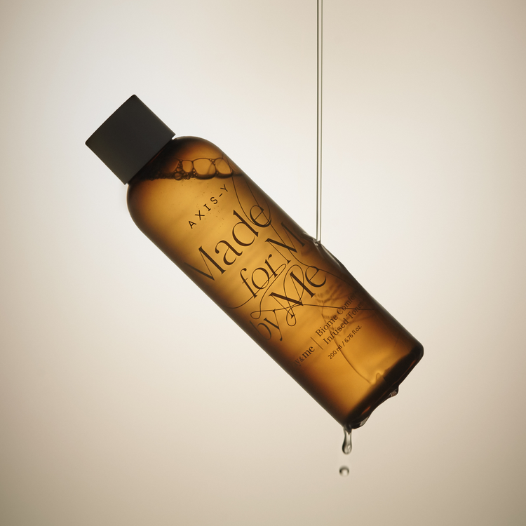AXIS-Y Biome Comforting Infused Toner 200ml by ProtoClinical shown in a product detail graphic with the toner packaging and branded design elements for a k-beauty skincare routine.