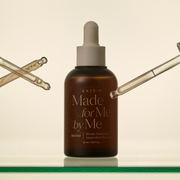 AXIS-Y Biome Radiating Intensified Essence 50ml by ProtoClinical displayed in a branded skincare graphic with the essence packaging and product details for a k-beauty routine.