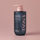 ProtoClinical k-beauty UNOVE DEEP DAMAGE REPAIR SHAMPOO 500ml single upright dark shampoo bottle centered on a soft pink background.