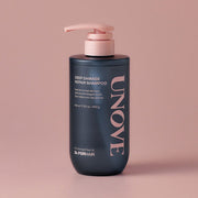 ProtoClinical k-beauty UNOVE DEEP DAMAGE REPAIR SHAMPOO 500ml single upright dark shampoo bottle centered on a soft pink background.
