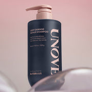 ProtoClinical k-beauty UNOVE DEEP DAMAGE REPAIR SHAMPOO 500ml single upright dark shampoo bottle centered on a soft pink background.