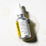 ProtoClinical k-beauty ilso CG Toning Serum 30ml in a dark gray bottle centered upright on a pale cream background with soft lavender side bands.