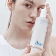 ProtoClinical k-beauty ilso Daily Moisture Softening Lotion 150ml single upright lotion bottle centered on a soft beige background with muted gray side shading.