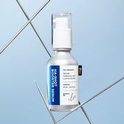 ProtoClinical k-beauty beauty product packaging in warm beige and brown tones on a light background.