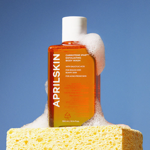 APRILSKIN Carrotene IPMP Exfoliating Body Wash 300ml by ProtoClinical displayed in a neat skincare layout featuring the exfoliating body wash bottle for a k-beauty body care routine.