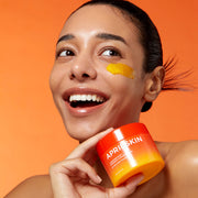APRILSKIN Carrotene IPMP Hydromelt Cleansing Balm 90ml by ProtoClinical displayed in a promotional skincare visual with the cleansing balm and lifestyle styling for a k-beauty routine.