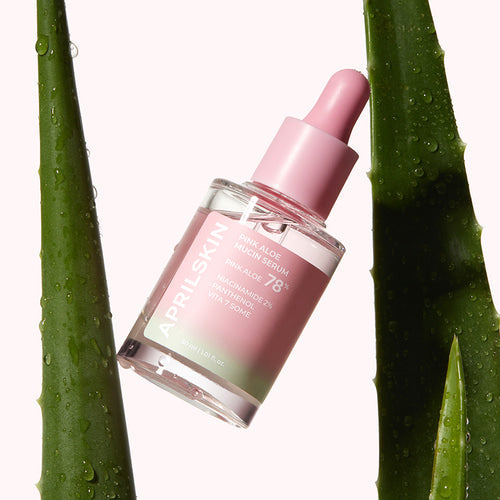 ProtoClinical k-beauty APRILSKIN Pink Aloe Mucin Serum 30ml three upright serum bottles side by side with a pink center bottle and dark green outer bottles on a light background