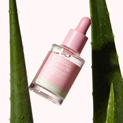 ProtoClinical k-beauty APRILSKIN Pink Aloe Mucin Serum 30ml three upright serum bottles side by side with a pink center bottle and dark green outer bottles on a light background