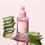 ProtoClinical k-beauty APRILSKIN Pink Aloe Mucin Serum 30ml three upright serum bottles side by side with a pink center bottle and dark green outer bottles on a light background