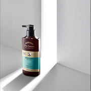 ProtoClinical k-beauty dark gray vertical beauty product silhouette on a light background with soft side highlights.