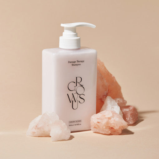 ProtoClinical k-beauty product packaging photo in warm beige and muted gray tones on a light background.