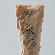 ProtoClinical k-beauty beauty product packaging with a warm brown vertical silhouette and pale blue side shading on a light background.