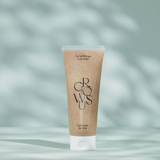 ProtoClinical k-beauty product packaging with warm bronze and cool blue accents on a light background.