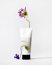 ProtoClinical k-beauty warm beige beauty product silhouette with a darker lower center on a light background.