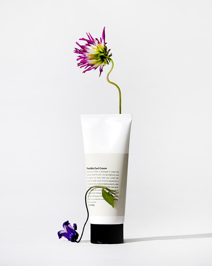 ProtoClinical k-beauty warm beige beauty product silhouette with a darker lower center on a light background.