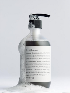ProtoClinical k-beauty pale blue beauty graphic with a centered gray vertical form on a light background.