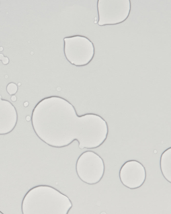 ProtoClinical k-beauty dark vertical beauty product silhouette on a light background.