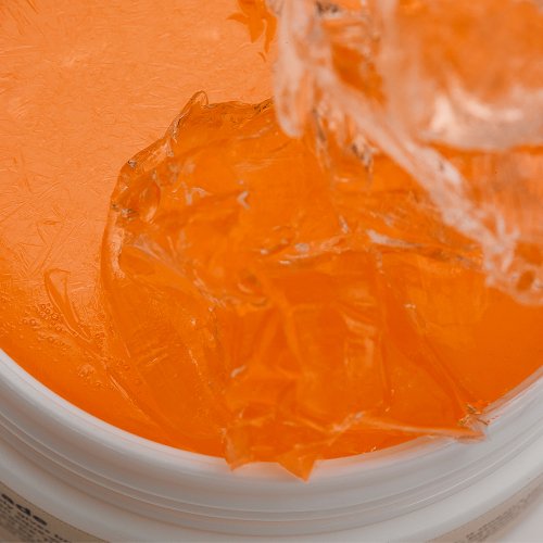 ProtoClinical k-beauty vivid orange beauty graphic with a darker orange lower band on a light background.
