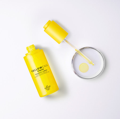 ProtoClinical k-beauty [so natural] Yellow Cica Ampoule 50ml shown with a yellow bottle and matching box on a pale cream and lavender background
