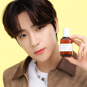 ProtoClinical k-beauty AMPLE:N Blemi Shot Ampoule 50ml lifestyle portrait of a person with dark hair wearing a mauve top against a warm light background