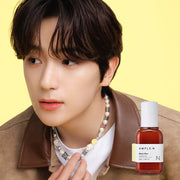 ProtoClinical k-beauty AMPLE:N Blemi Shot Ampoule 50ml lifestyle portrait of a person with dark hair wearing a mauve top against a light yellow background