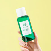 ProtoClinical k-beauty yellow and mint beauty product packaging on a pale background.