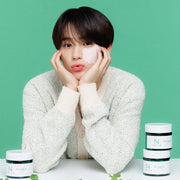 ProtoClinical k-beauty centered beauty product on a teal and pink background.