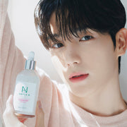 ProtoClinical k-beauty tall beauty product packaging on a soft beige background with a dark top.
