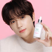 ProtoClinical k-beauty beauty product arrangement on a soft pink background.