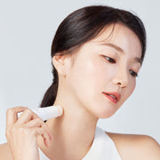 ProtoClinical k-beauty beige beauty product packaging on a light background.
