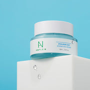 ProtoClinical k-beauty centered beauty product on a soft aqua and beige background.