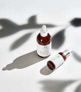 ProtoClinical k-beauty neutral-toned product packaging on a light background.