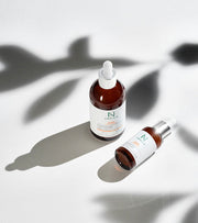 ProtoClinical k-beauty neutral-toned product packaging on a light background.