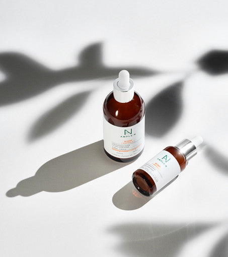 ProtoClinical k-beauty neutral-toned product packaging on a light background.