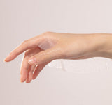 ProtoClinical k-beauty V&A BEAUTY Antioxidant Ampoule Mask Sheet 25ml x 5EA with a hand swatch of glossy serum and a translucent sheet mask draped across the wrist on a pale background