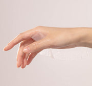 ProtoClinical k-beauty V&A BEAUTY Antioxidant Ampoule Mask Sheet 25ml x 5EA with a hand swatch of glossy serum and a translucent sheet mask draped across the wrist on a pale background