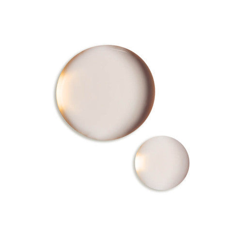 ProtoClinical k-beauty pale gray beauty product silhouette with a soft peach lower edge on a light background.