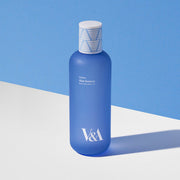 ProtoClinical k-beauty blue beauty bottle silhouette centered on a bright blue background with a pale lower edge.