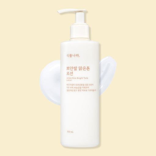 ProtoClinical k-beauty Shingmulnara White Rice Bright Tone Lotion 300ml in a single centered upright packshot with soft beige-pink tones and pale yellow side shading on a light background