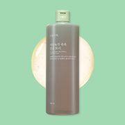 ProtoClinical k-beauty Shingmulnara Young Green Tea Watery Calming Toner 500ml shown in a single centered upright packshot in muted charcoal tones on a soft mint green background