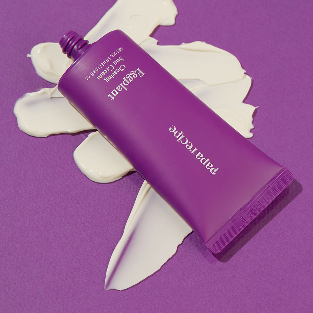 ProtoClinical k-beauty papa recipe Eggplant Clearing Sun Cream 50ml (SPF 50+ PA++++) promotional panel with a close-up of a woman's forehead, black Korean text, and a lavender-and-white background