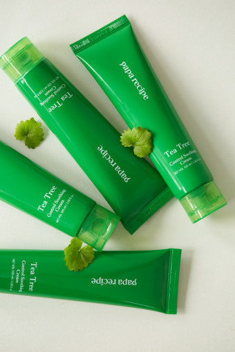 ProtoClinical k-beauty papa recipe Tea Tree Control Soothing Cream 100ml single upright green cream tube centered on a white background with soft pink side accents.