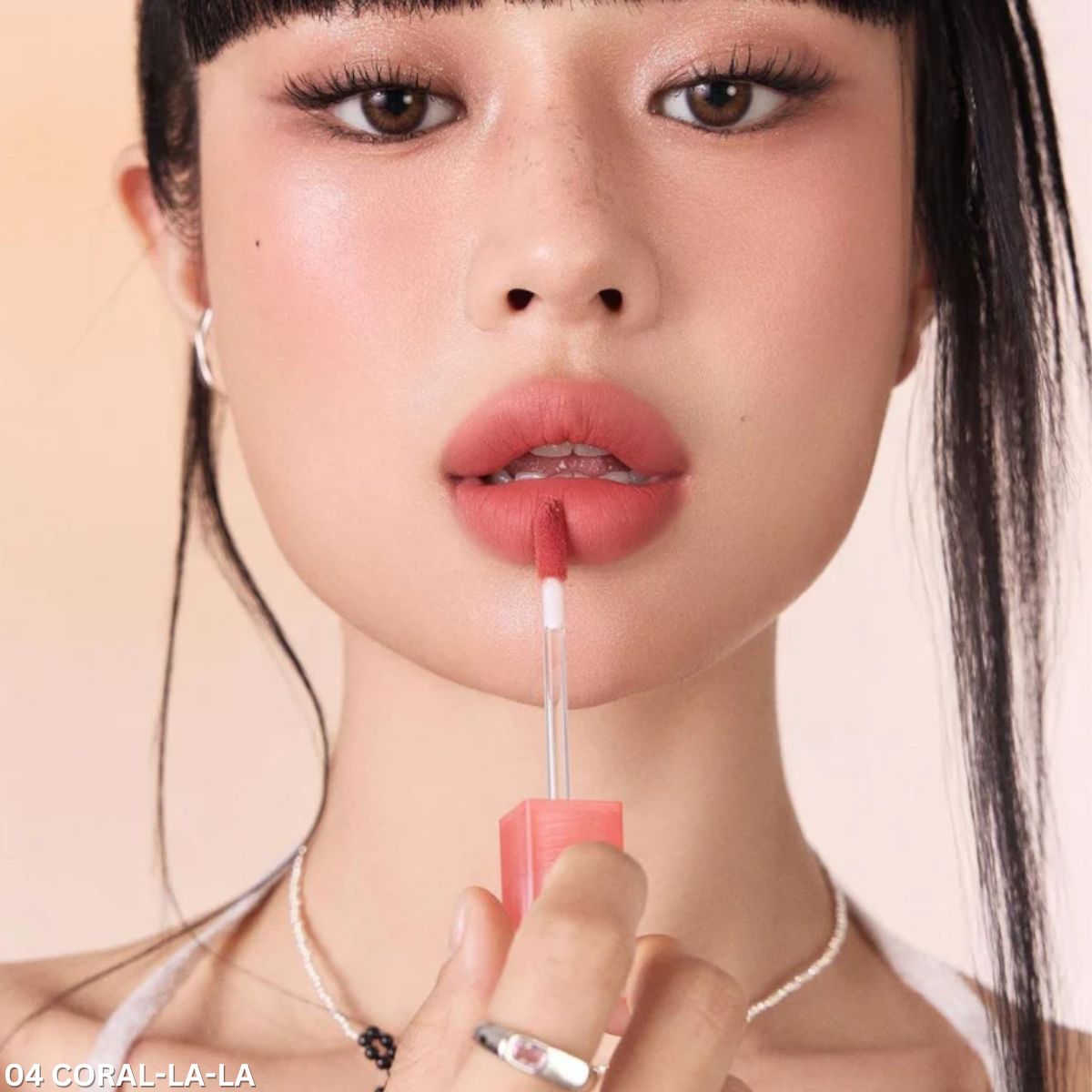 ProtoClinical k-beauty peripera Over Blur Tint 3.5g single rose-beige lip tint tube centered on a soft beige and brown background