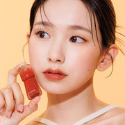 ProtoClinical k-beauty dark brown beauty product packaging on a light background.