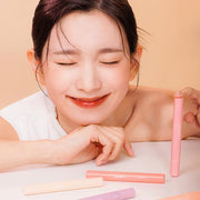 ProtoClinical k-beauty warm brown beauty product packaging on a light background.